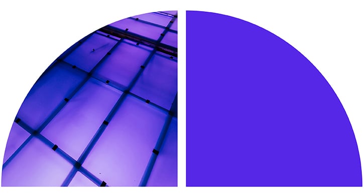 A purple-tinted architectural ceiling with a grid pattern.