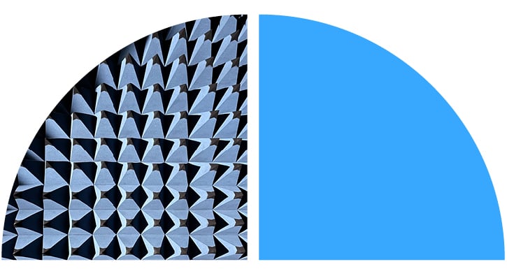 Blue geometric cone shapes stand against black shadows.